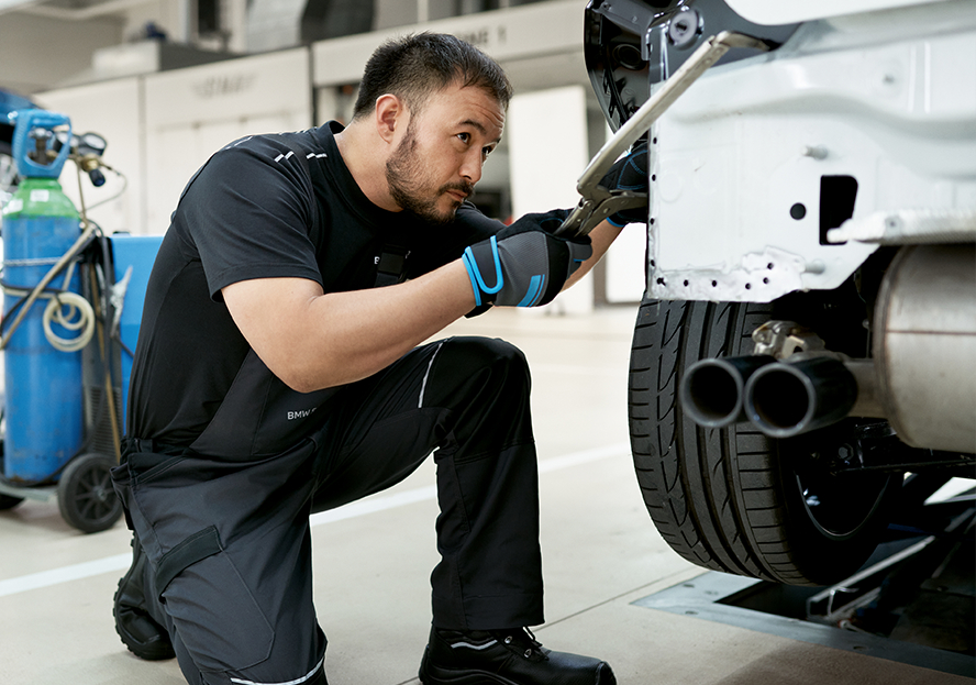 BMW Trained Technician performs bonding and riveting repair on a BMW vehicle in a BMW Certified Collision Repair Center.